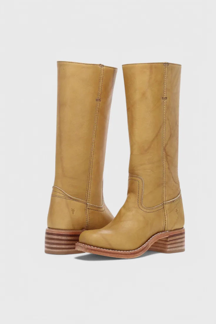 Front and side view of mustard yellow knee-high leather boots showing natural grain and stitched instep seam