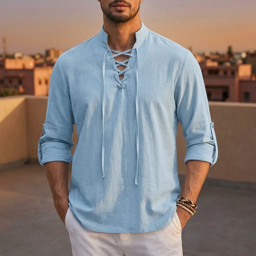 Close-up of a light blue lace-up shirt showing the crisscross cord detail at the neckline