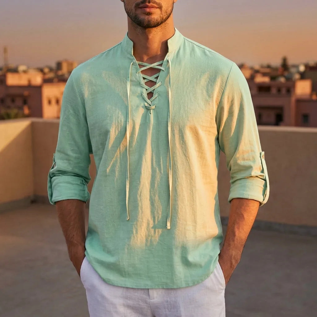 Sage green lace-up shirt with mandarin collar worn with the sleeves rolled and buttoned