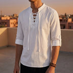 White lace-up Renaissance shirt with long sleeves paired with dark trousers