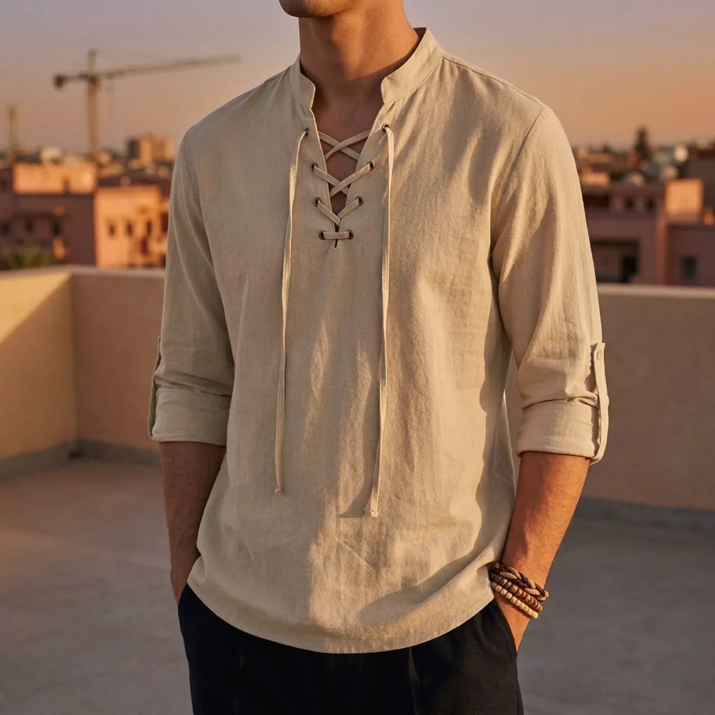 Beige lace-up shirt with mandarin collar and roll-tab sleeves worn on a terrace