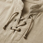 Close-up of the bronze eyelets and woven lace-up cords on a beige cotton-linen shirt collar