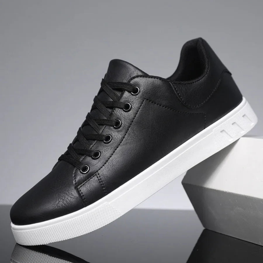 Side profile of black leather sneaker with black laces, black lining and contrasting white sole