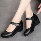 Top down view of burgundy leather Mary Jane wedge shoes displaying the stitched topline and strap closure