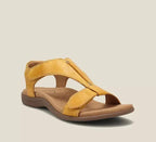 Mustard yellow leather sandal featuring crossover straps, reinforced stitching and a cushioned tan footbed, side angle view.