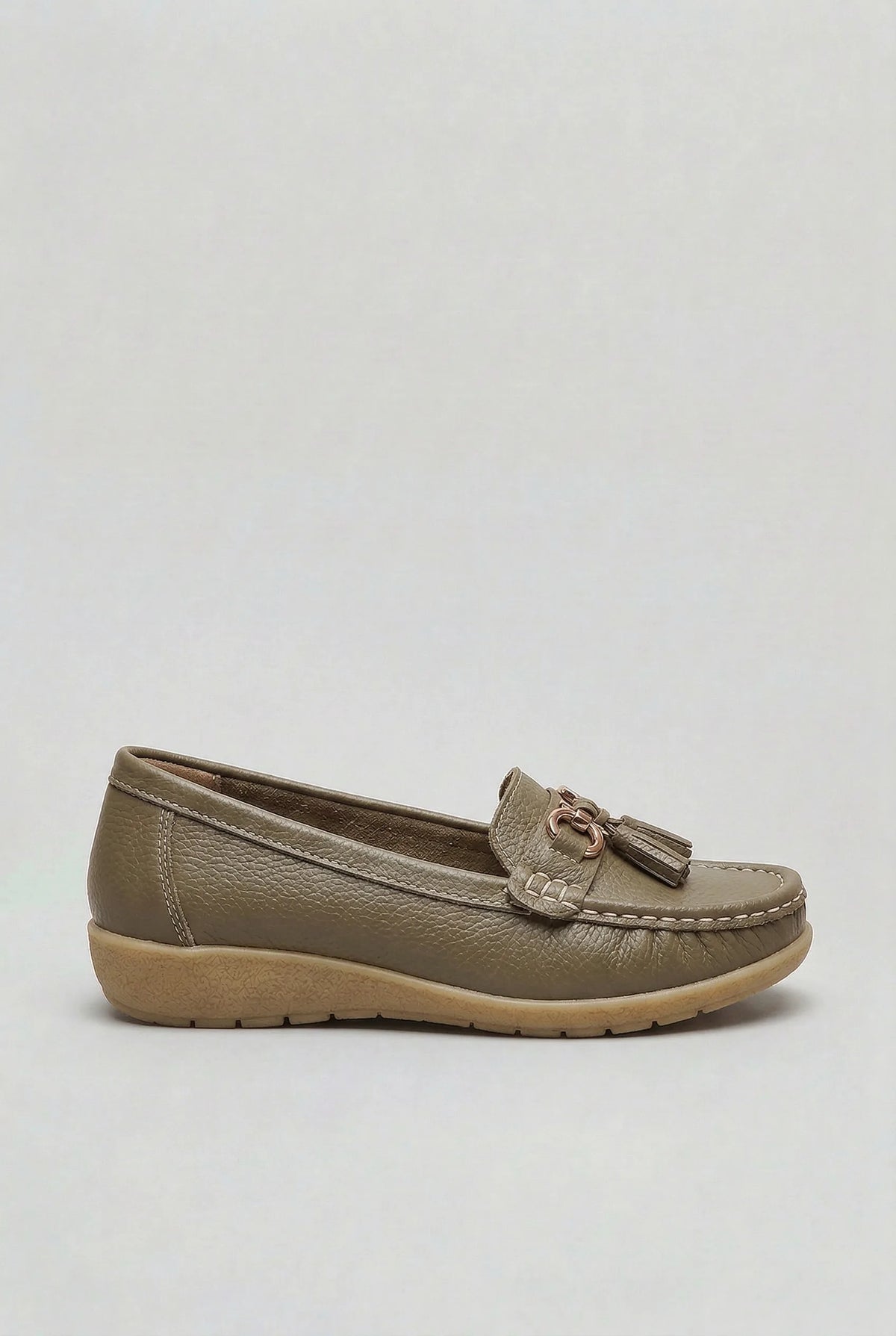 Side profile of a taupe leather loafer with gold-tone hardware and stitched apron toe