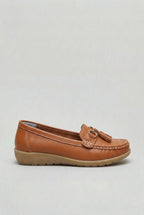 Side profile of a tan leather loafer with gold-tone tassel trim and contrast topstitching