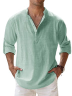Cropped front view of a man wearing the shirt in sage green, showing the relaxed drape and rolled-up sleeves.