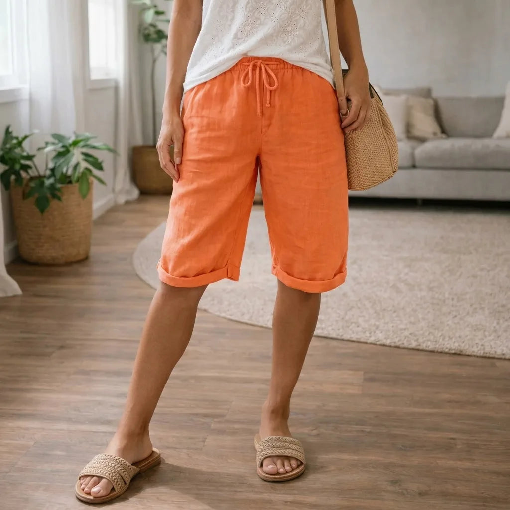 Orange linen knee-length shorts with rolled hem, drawstring tie and side pockets, worn with a lace-trim singlet