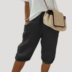 Black linen bermuda shorts shown with drawstring waistband and relaxed, loose-fitting leg