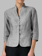 Front view of a heather grey linen blazer highlighting the textured woven fabric and shell buttons