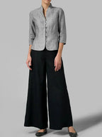 Full-length view of a heather grey linen blazer styled with black wide-leg trousers and flat shoes