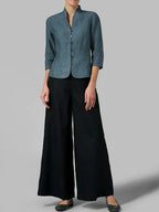 Full-length view of a slate blue-grey linen blazer paired with black wide-leg trousers and black flats