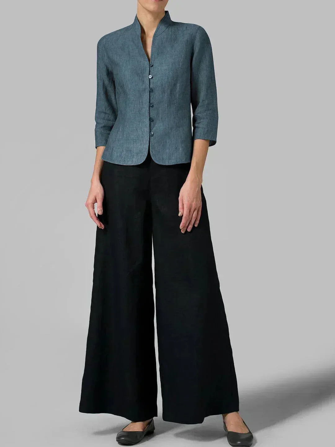 Full-length view of a slate blue-grey linen blazer paired with black wide-leg trousers and black flats