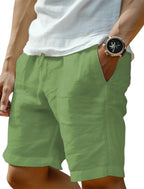 Close-up of a man's hip and thigh wearing sage green linen-blend shorts with a drawstring waist and side pocket