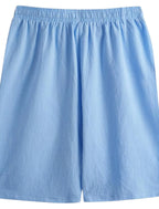 Flat lay of light blue shorts showing elastic waistband and soft lightweight fabric texture