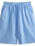 Flat lay of light blue shorts with elastic drawstring waist and two patch-style side pockets