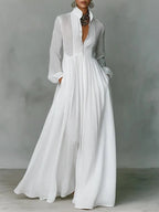 Front view of a white long-sleeve maxi shirt dress with stand collar, button placket and flowing wide skirt
