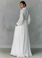 Back view of the white maxi shirt dress showing the fitted bodice, side pocket and sweeping floor-length hem