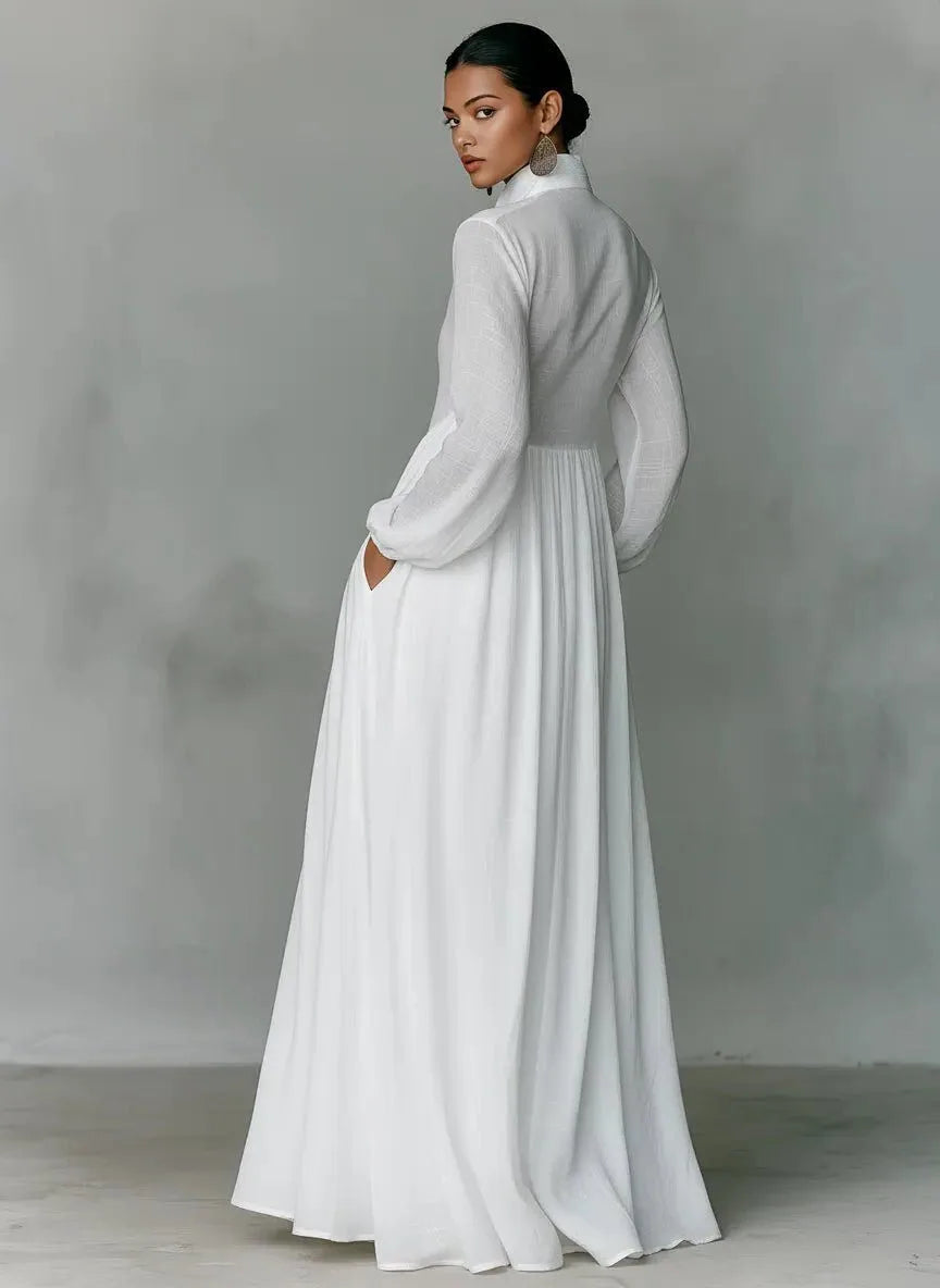 Back view of the white maxi shirt dress showing the fitted bodice, side pocket and sweeping floor-length hem