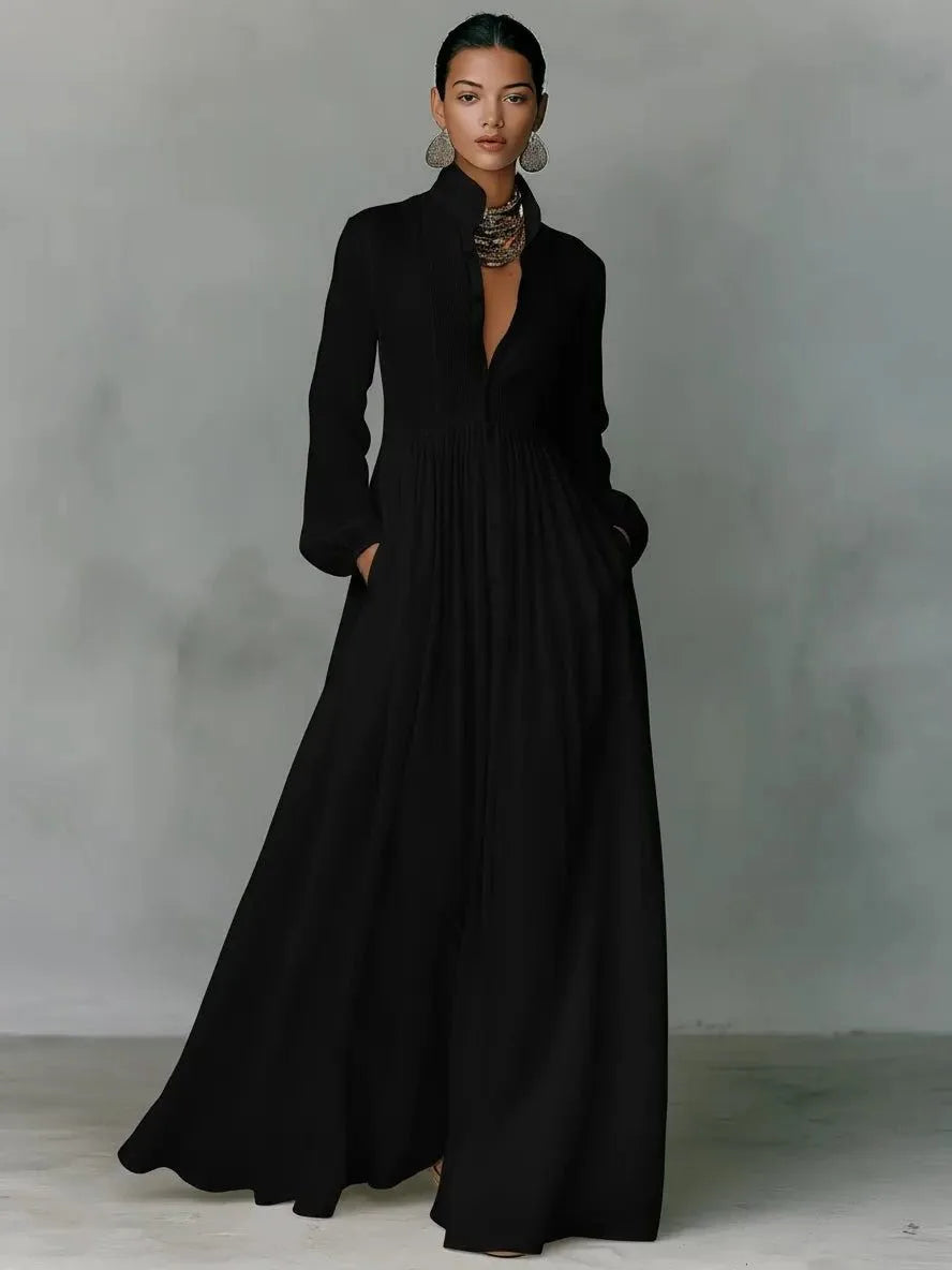 Black long-sleeve maxi shirt dress with stand collar, button-front bodice and hand tucked into side pocket