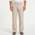 Man modelling sand beige linen trousers with elasticated drawstring waist and side pockets