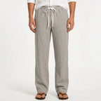 Man wearing light grey heathered linen trousers with white drawstring waistband and sandals