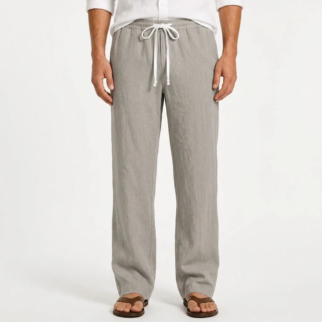 Man wearing light grey heathered linen trousers with white drawstring waistband and sandals