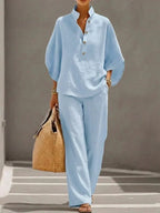 Light blue version of the relaxed set, front view showing the stand collar, button placket and billowy dropped sleeves.