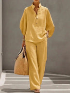 Yellow two-piece outfit showing the button-up collared top and matching wide-leg pants in a soft, breathable fabric.