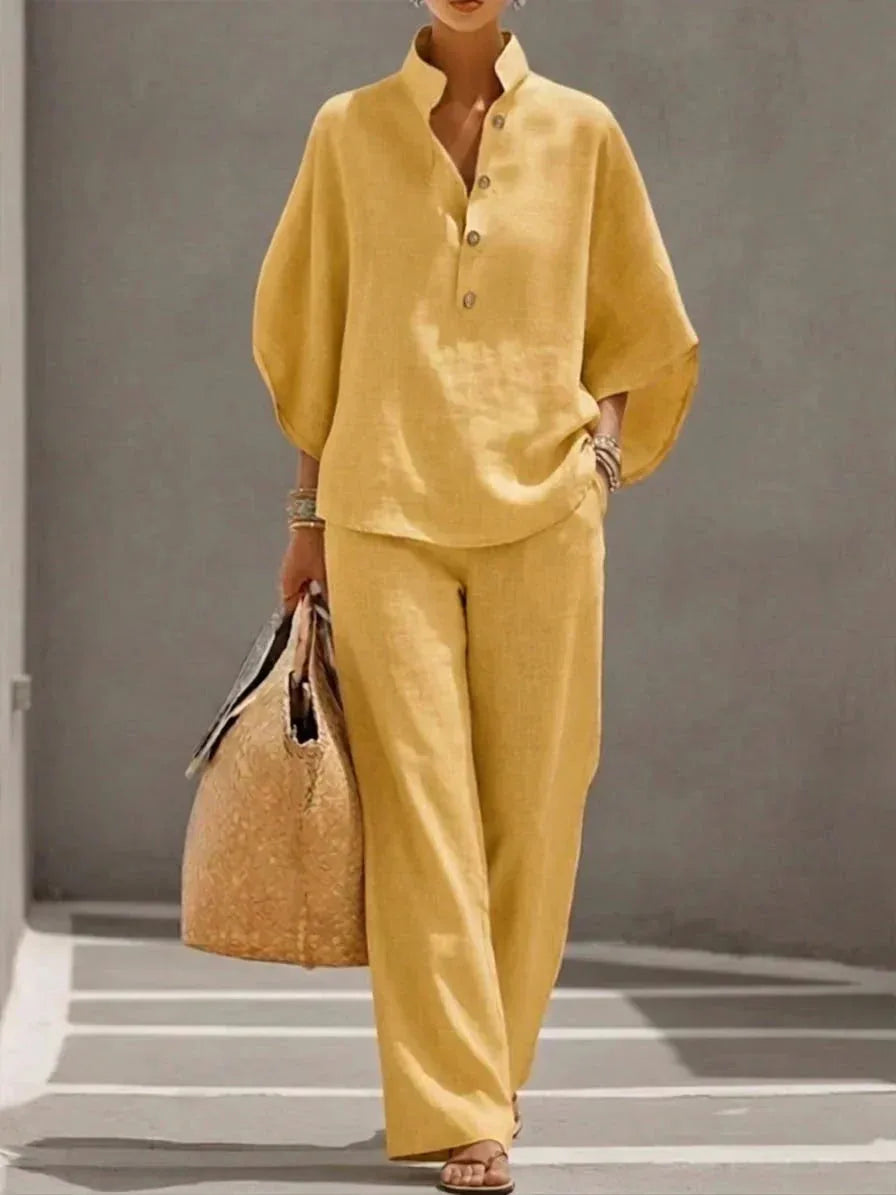 Yellow two-piece outfit showing the button-up collared top and matching wide-leg pants in a soft, breathable fabric.