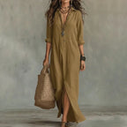 Khaki coloured collared shirt dress in a flowing fabric, worn with sandals and a straw bag