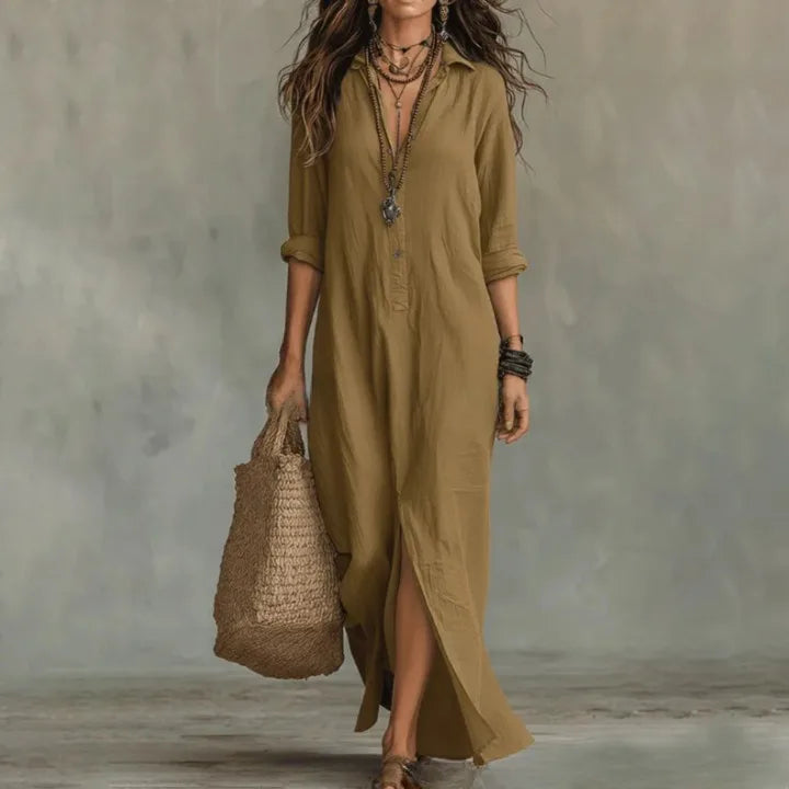 Khaki coloured collared shirt dress in a flowing fabric, worn with sandals and a straw bag