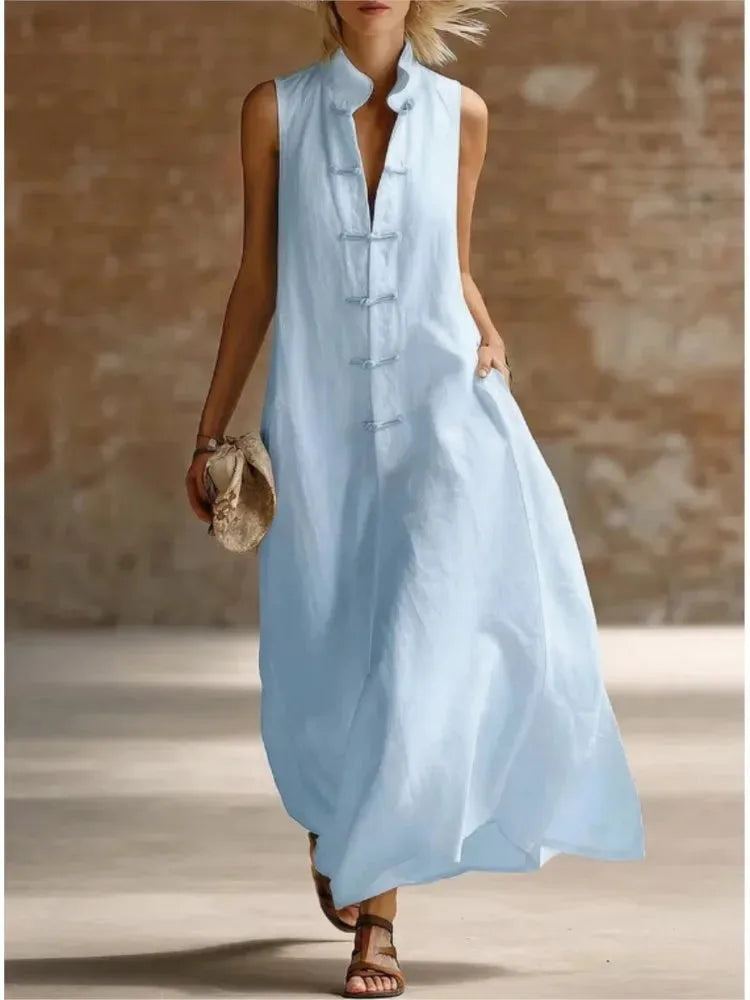 Sky blue linen maxi dress with mandarin collar and frog button closure, styled with leather sandals