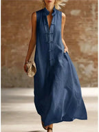 Navy blue sleeveless maxi dress with frog button closure and stand collar, lightweight flowing fabric