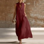 Red maxi dress with mandarin collar and frog buttons, full skirt moving in the breeze