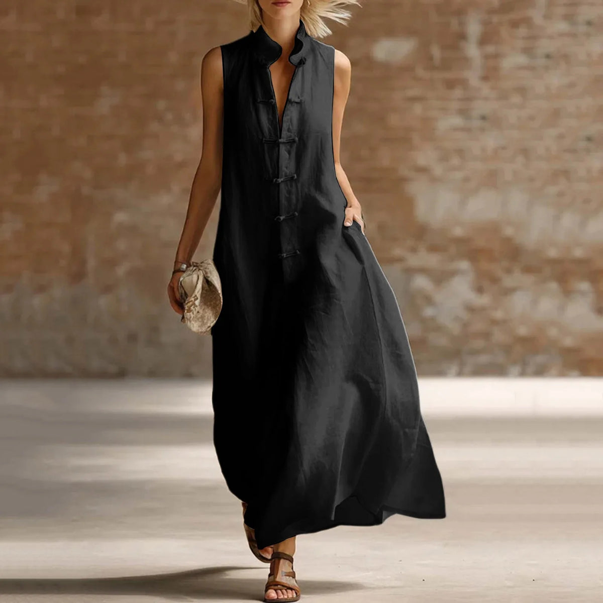 Black sleeveless linen-style maxi dress with frog fastenings, relaxed fit shown from the front