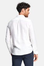Back view of white linen shirt showing relaxed fit across the shoulders and back yoke