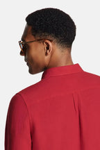 Close-up back view of the burgundy shirt showing collar detail and natural linen weave