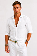 Model showing the relaxed, close fit of the linen shirt through the torso, paired with white chino trousers and a braided belt.