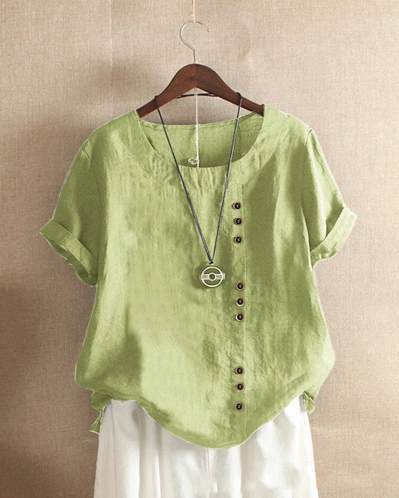 Light green linen blouse close-up, showing the natural fabric texture and row of small buttons
