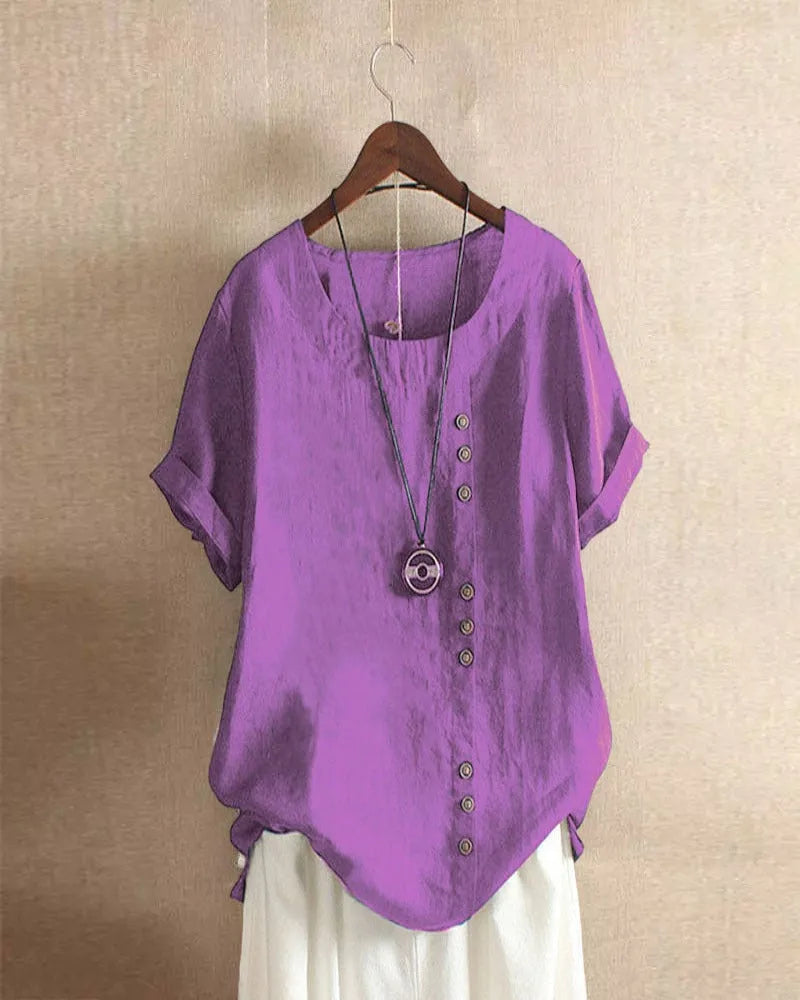 Full-length view of the blouse styled with a flowing white skirt, showing how the curved hem falls at the hip