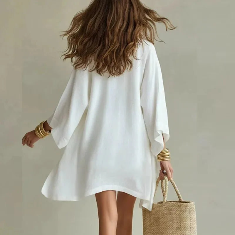 Back view of the white linen kimono cardigan showing its relaxed, loose fit and flowing sleeves
