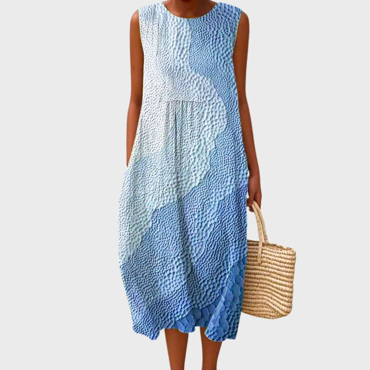 Sleeveless midi dress in a textured blue and white ombre pattern with a pebbled finish, loose flowing cut