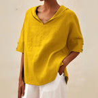Mustard yellow linen V-neck blouse with dropped shoulders, showing the oversized relaxed fit