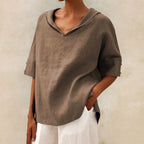 Taupe linen V-neck blouse with soft draping fabric and a sailor style collar, side angle view