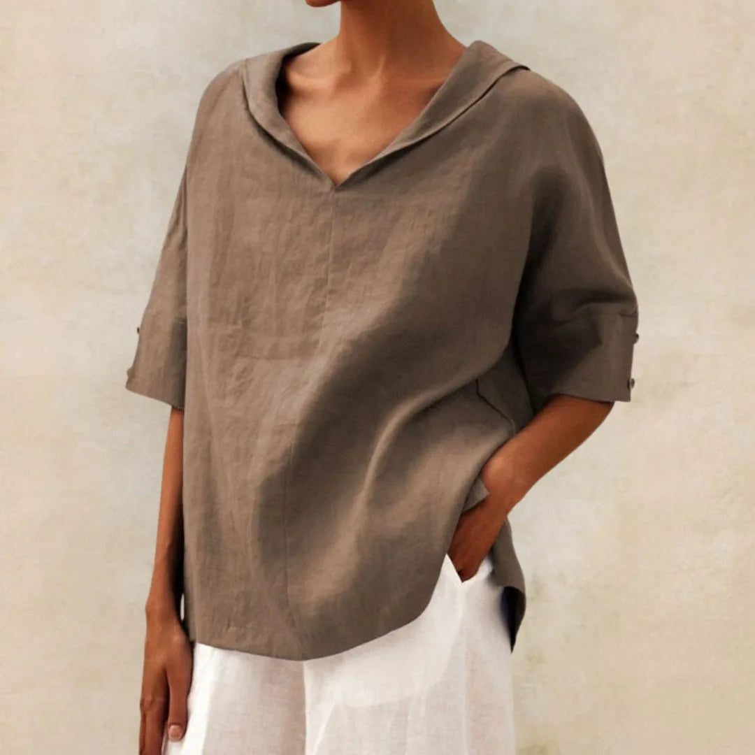 Taupe linen V-neck blouse with soft draping fabric and a sailor style collar, side angle view