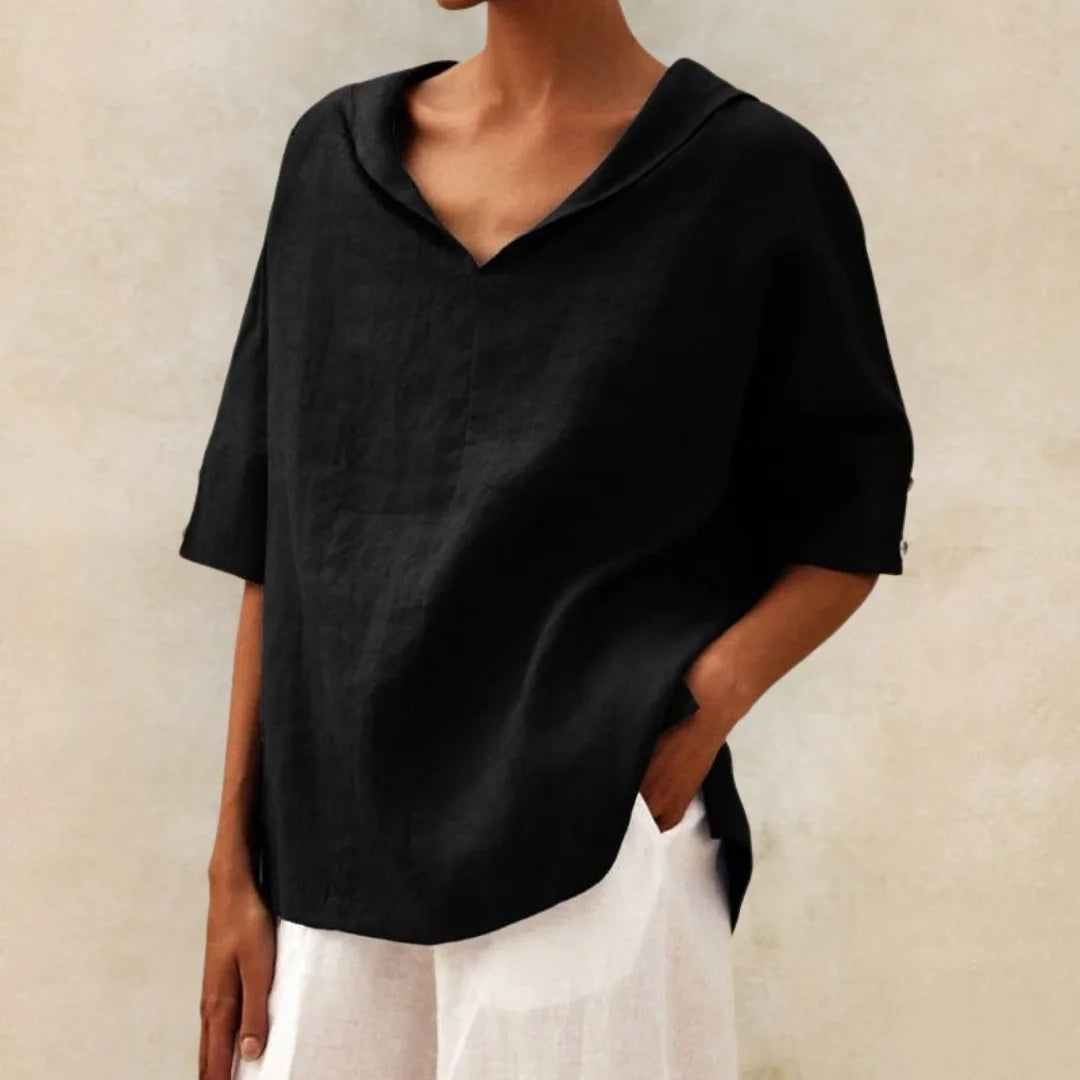 Black linen V-neck blouse with relaxed collar and rolled sleeves, shown against a plain backdrop