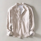 Beige collarless linen shirt flat lay, showing front buttons and natural fabric texture