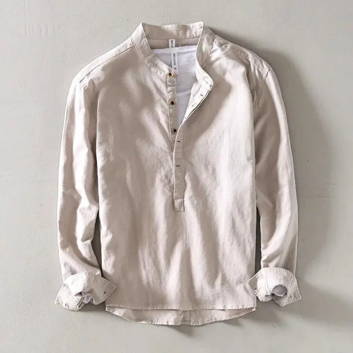Beige collarless linen shirt flat lay, showing front buttons and natural fabric texture